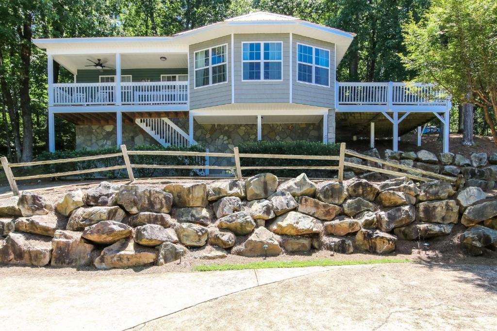 a large house with a rock wall in front of it at House #17 On The Rocks (no pets) Lake View in Centre