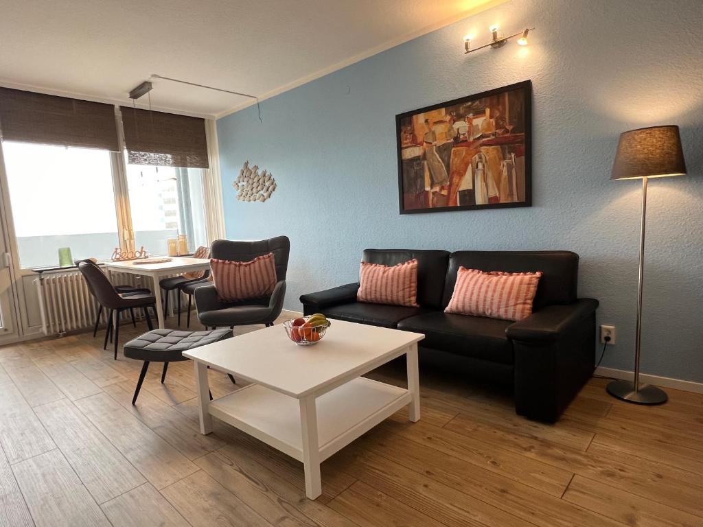 a living room with a couch and a table at Ostseeliebe M-5-6 in Heiligenhafen