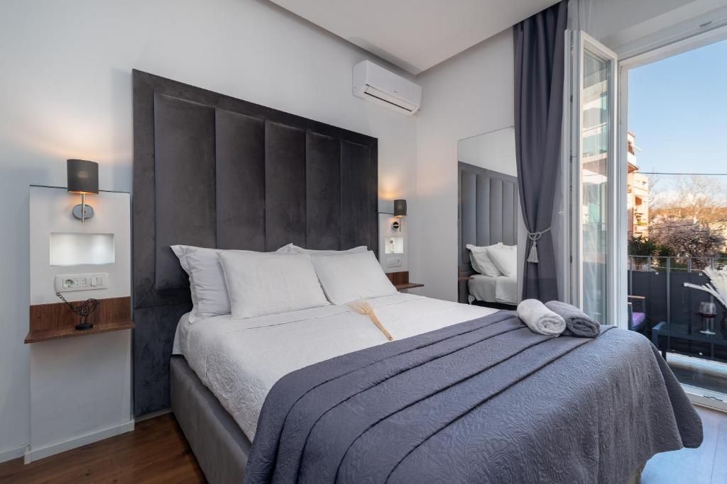 a bedroom with a large bed and a large window at Antares Luxury Rooms 2 in Split