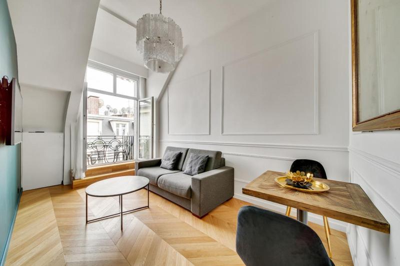 a living room with a couch and a table at 240 Suite Elysée - Superb apartment in Paris in Paris