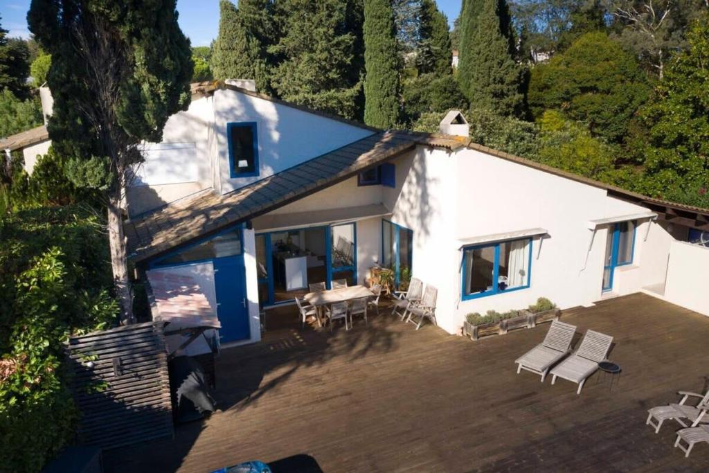 an aerial view of a white house with a patio at 06V - Beautiful villa with spa pool and tennis in Biot
