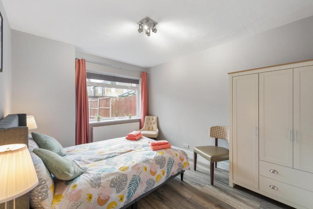 a bedroom with a bed and a window at Edgware Oasis: Modern Haven near Tube & Park in Edgware