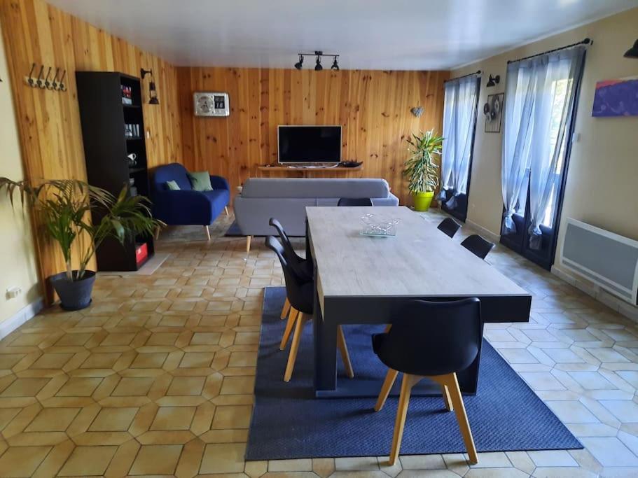 a living room with a dining table and chairs at Appartement tout confort , centre Loudenvielle in Loudenvielle