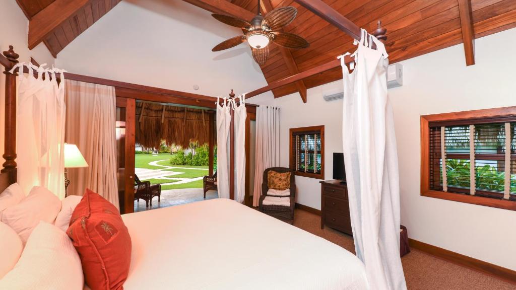 a bedroom with a bed and a ceiling fan at Victoria House Resort & Spa in San Pedro