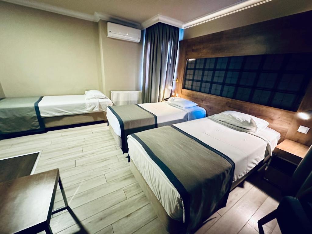 Postel nebo postele na pokoji v ubytování Laodikya Hotel