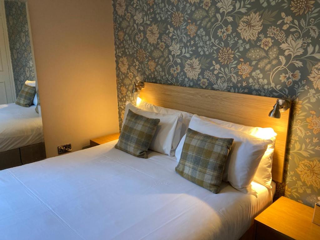 a hotel room with a bed with two pillows at The Oxnoble in Manchester