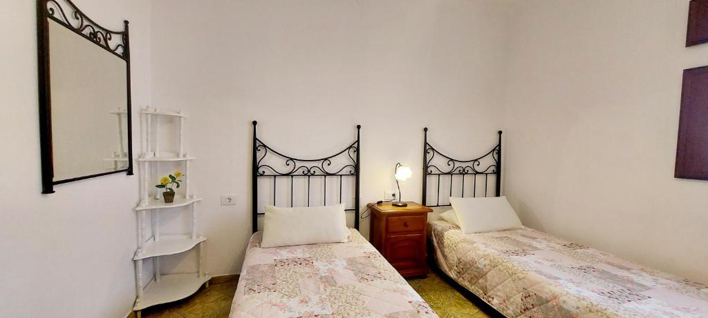 a bedroom with two beds and a mirror at 10 km From Airport in Vecindario