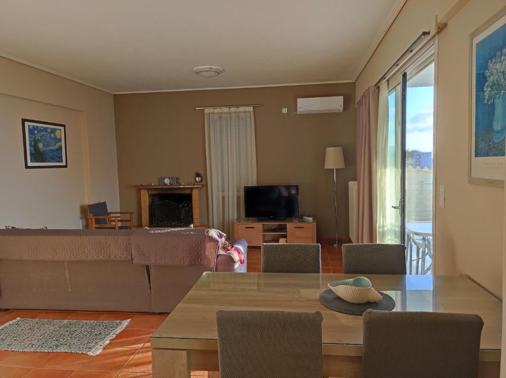 a living room with a couch and a table at Galini Apartments in Kalamata