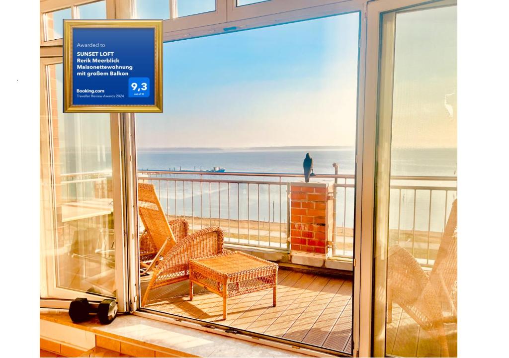 a balcony with chairs and a view of the ocean at SUNSET LOFT Rerik Meerblick Maisonettewohnung mit großem Balkon in Rerik