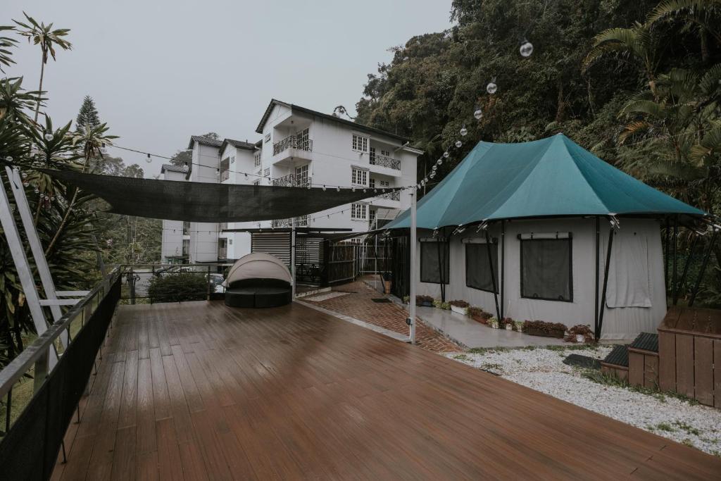 a house with a green tent on a wooden deck at kMah@Parkland in Brinchang