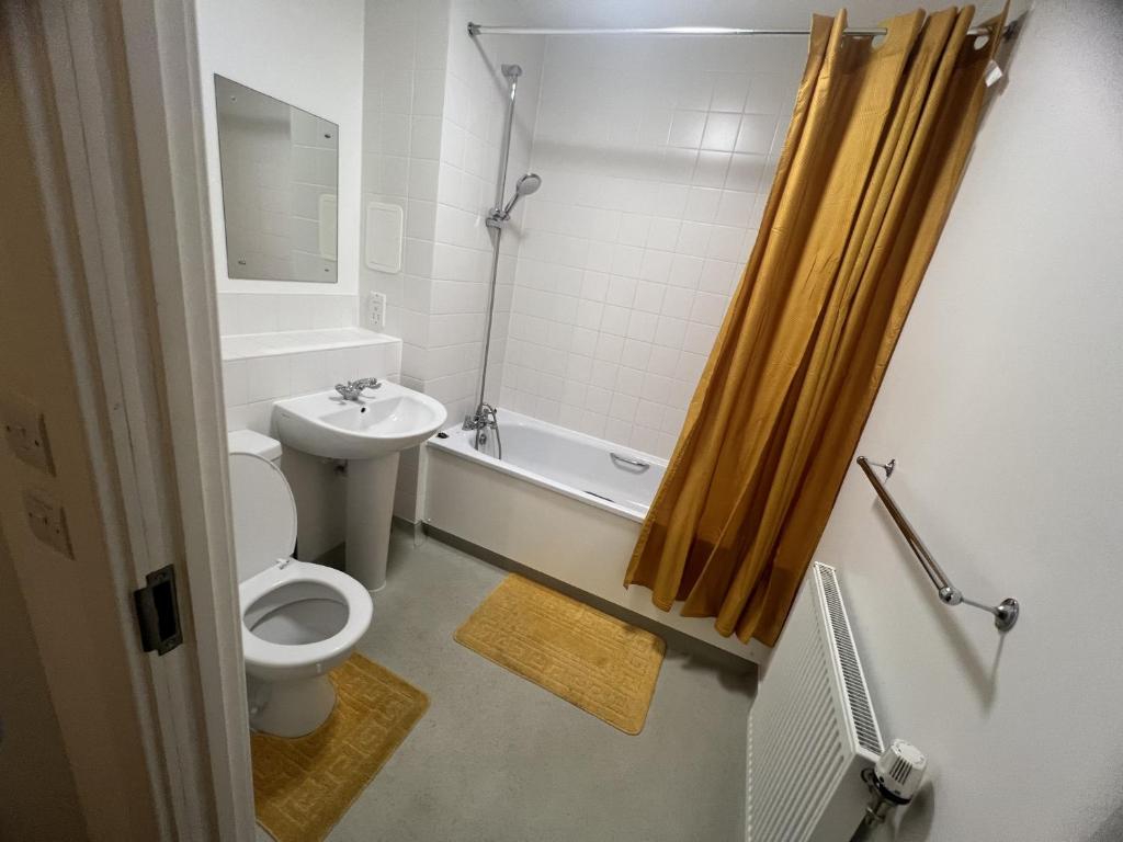 a bathroom with a toilet and a sink and a shower at Private Flat in London in London