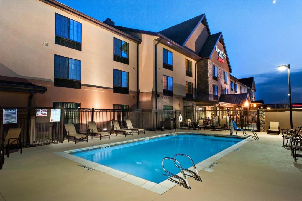 a hotel with a swimming pool in front of a building at TownePlace Suites by Marriott Roswell in Roswell