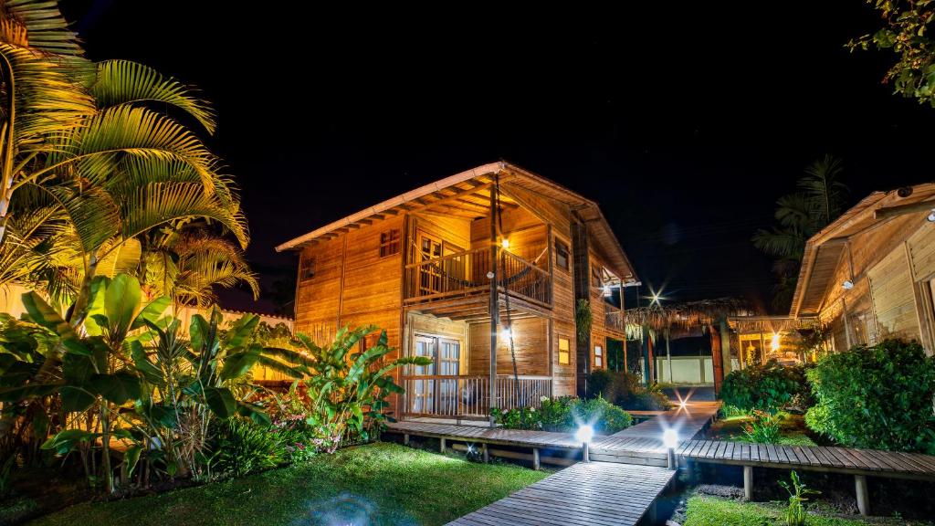 a wooden house with a wooden walkway outside at night at Hotel Terasu Salento in Salento