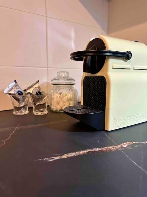 a toaster sitting on top of a kitchen counter at Appartement cosy de standing in Mondonville