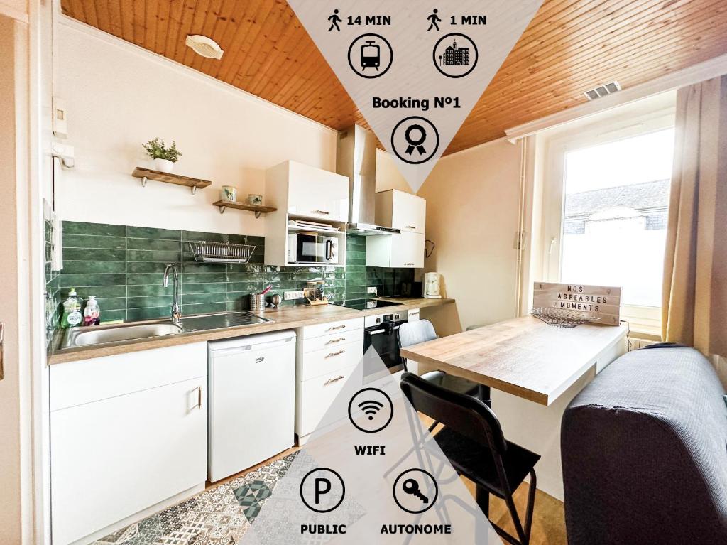 a kitchen with white cabinets and a wooden table at II-Charmant Appartement au coeur de la ville in Guingamp