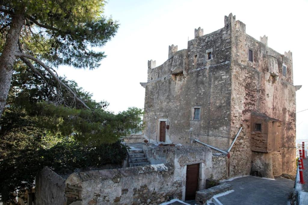 an old stone building with stairs in front of it at Tower of Dellarokas in Mélanes