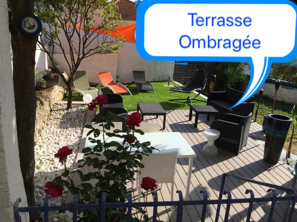 une image d'un jardin avec un panneau indiquant l'entrée de la terrasse dans l'établissement Appartement dans la villa 