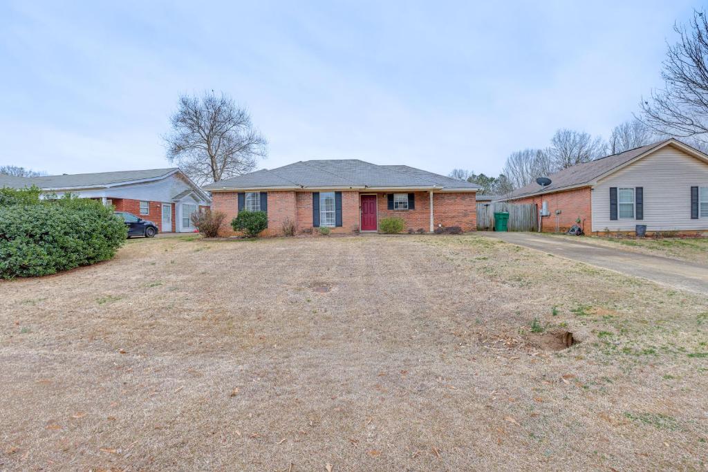 a house with a dirt driveway in a yard at Pet-Friendly Millbrook Home with Covered Patio! in Millbrook