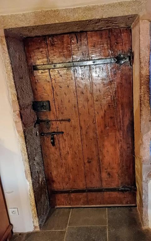 an old wooden door in a room at La MIDAD in La Chapelle-Thècle