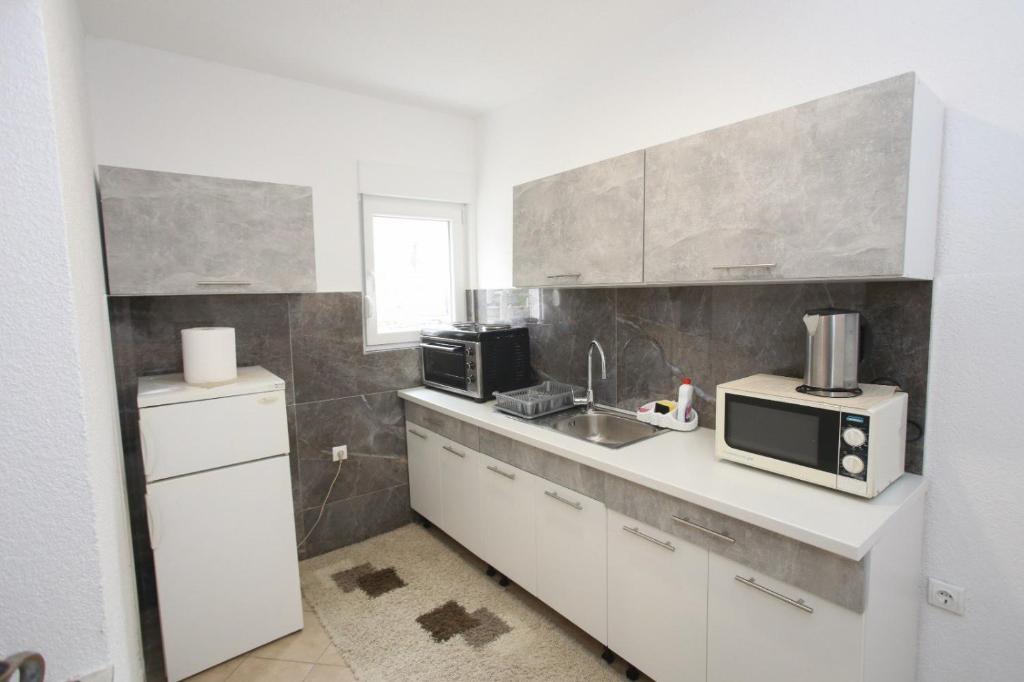 Kuchyň nebo kuchyňský kout v ubytování Apartments Daris