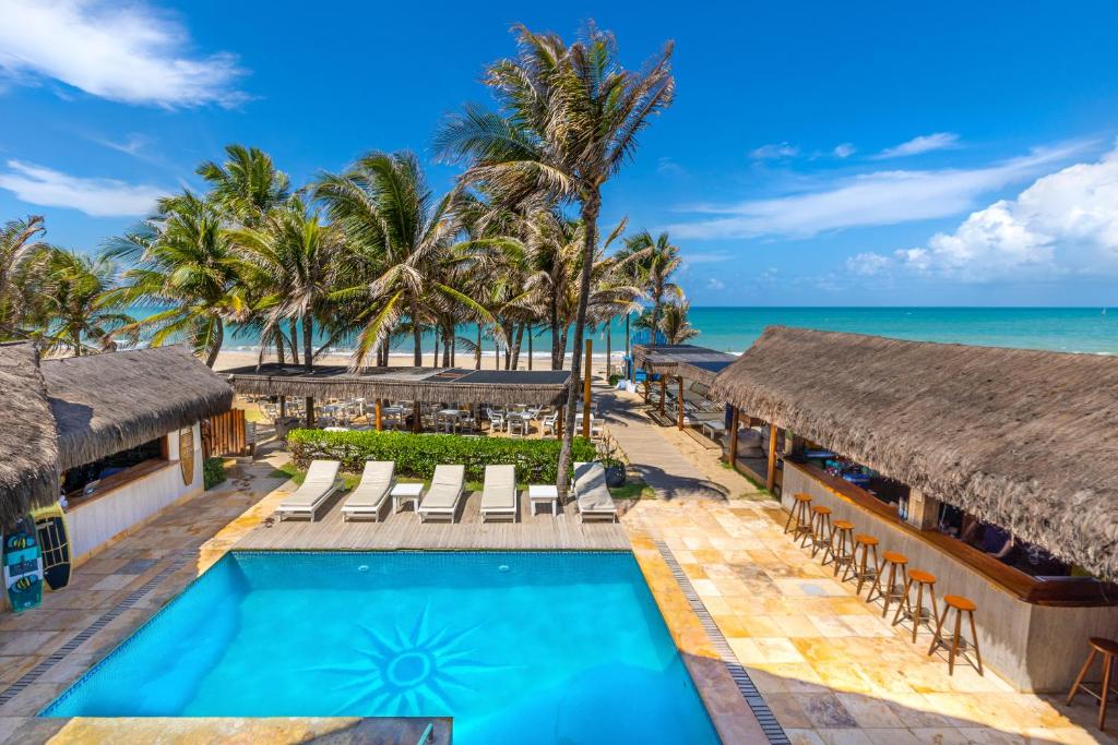 an image of a resort with a swimming pool and the ocean at Vila Coqueiros Boutique Hotel in Cumbuco