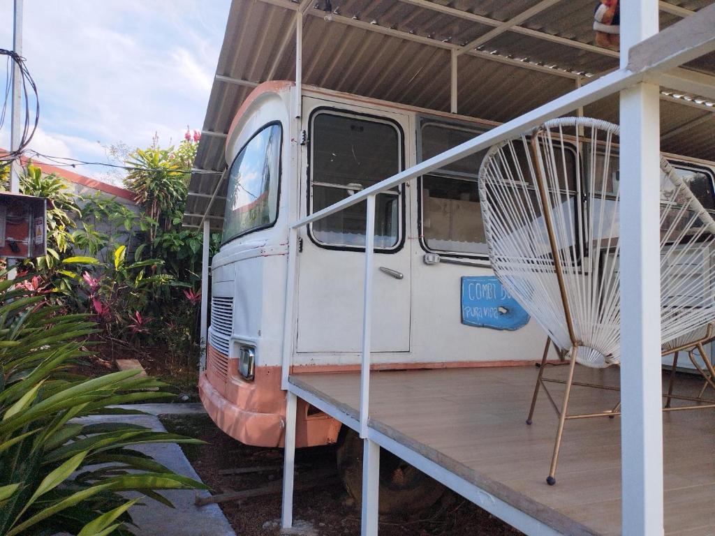 an old van parked in a building with a fan at Combi Bus Dreamcatcher in Sarchí