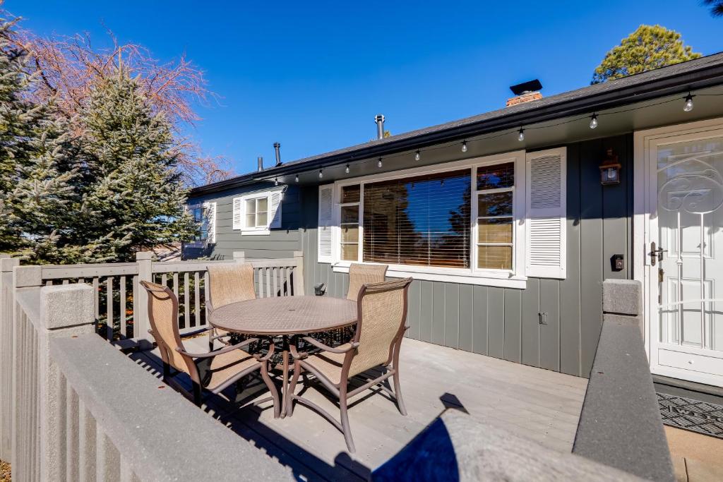 a patio with a table and chairs on a balcony at Williams Cottage with Patios and Grill Near Route 66 in Williams