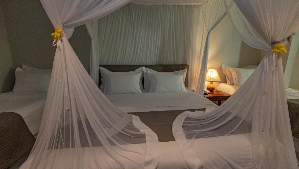 Postel nebo postele na pokoji v ubytování Aysú Trancoso Boutique Hotel