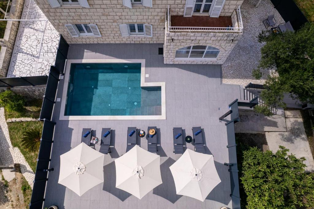 an overhead view of a swimming pool with umbrellas at Villa Nono in Dubrovnik
