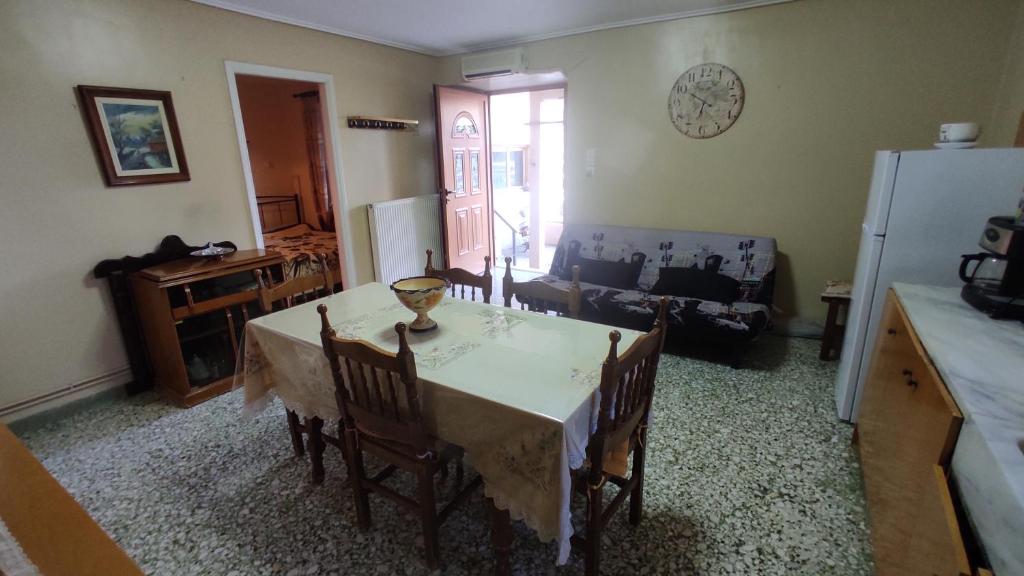 a kitchen with a table and chairs in a room at Carnival house in Ámfissa