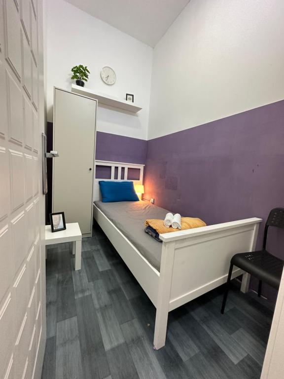 a bedroom with a bed with a purple wall at Calm Partition Room Near Mashreq Metro in Dubai