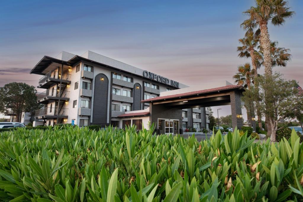 a building with a lot of plants in front of it at Oxford Suites Lancaster in Lancaster