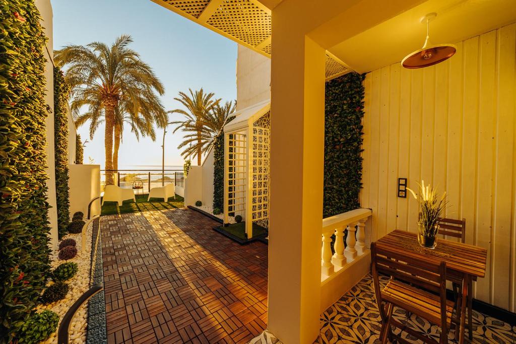 a balcony of a house with a bench and palm trees at HOSTAL LUXURY NIT I DIA in Altea