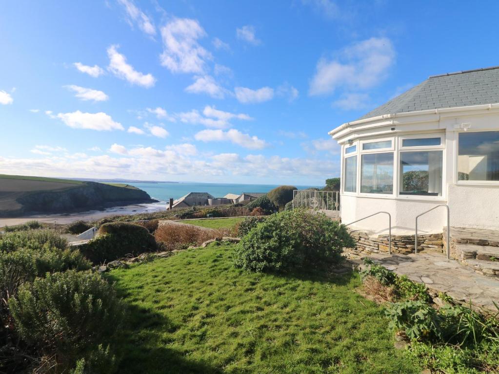 a house with a view of the ocean at Gwillen in Mawgan Porth