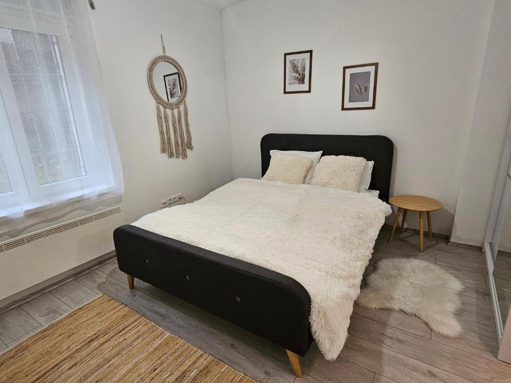 a bedroom with a bed and a mirror on the wall at Studio apartment Gigi in Zagreb