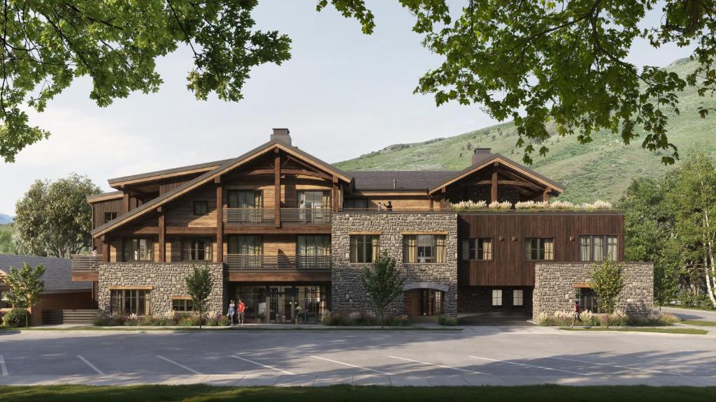 an exterior view of a lodge with mountains in the background at The Rusty Parrot Lodge and Spa in Jackson