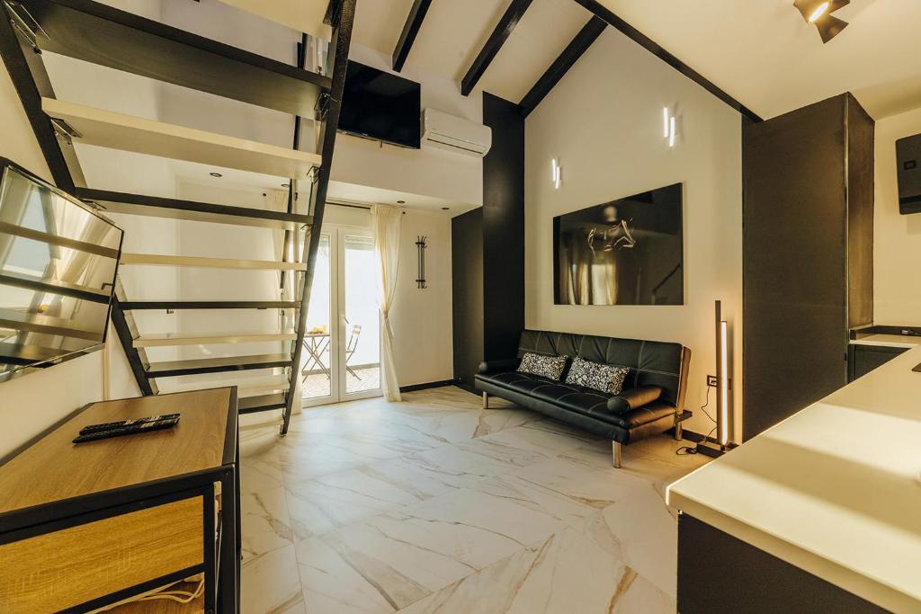 a living room with a staircase and a couch at HOSTAL LUXURY NIT I DIA in Altea