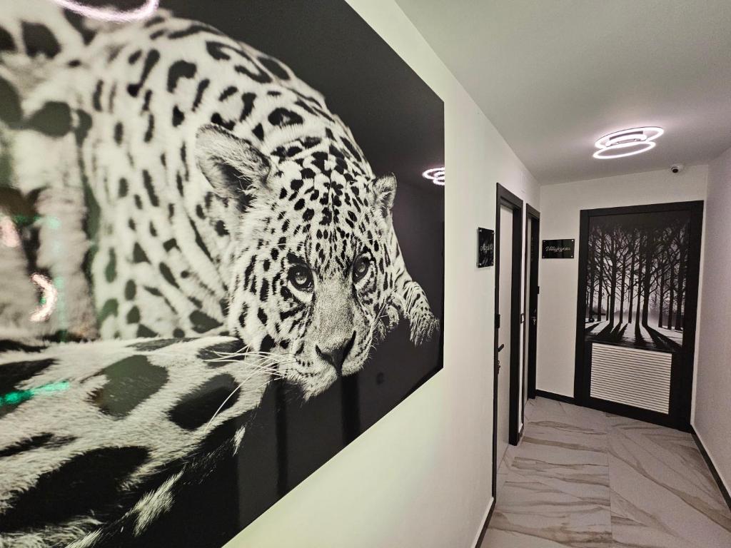 a painting of a leopard on the wall in a hallway at HOSTAL LUXURY NIT I DIA in Altea