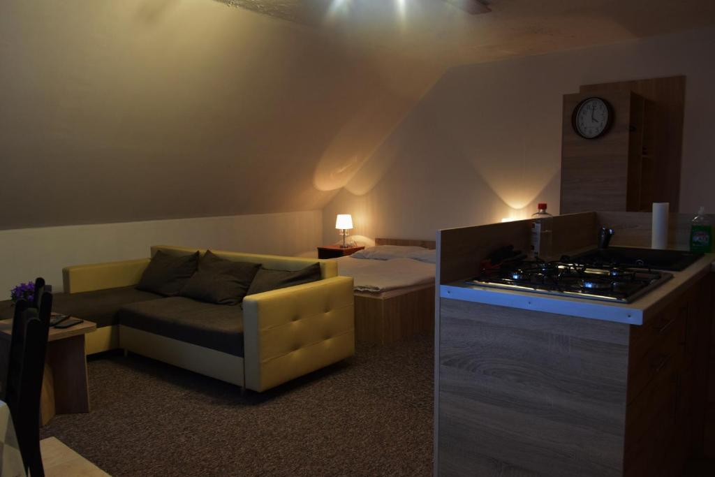 a living room with a couch and a table at Apartament Czos Kominek Premium in Mrągowo
