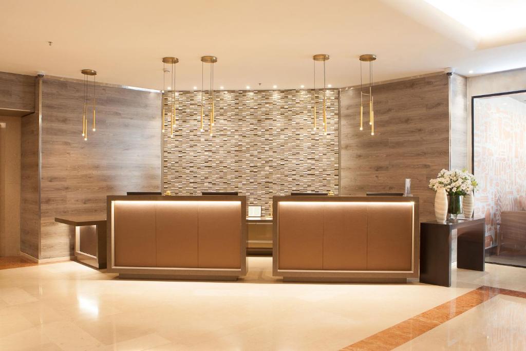 a lobby of a hotel with a stone wall at Le Méridien Santiago in Santiago