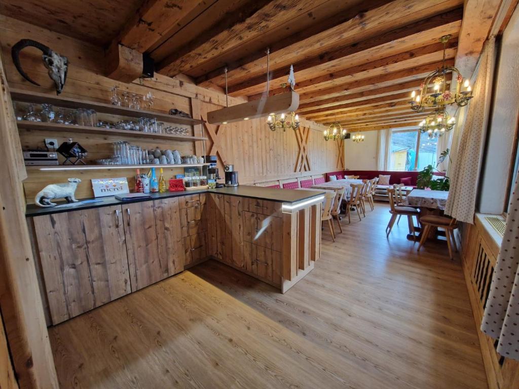 a restaurant with a bar and a dining room with tables at Panorama-Ferienhaus im Stubaital in Mieders