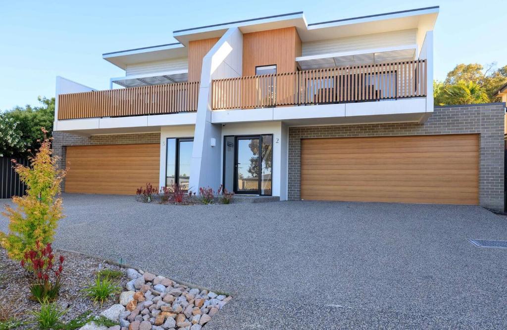 a bedroom house with a balcony and a garage at Neddidge in Albury