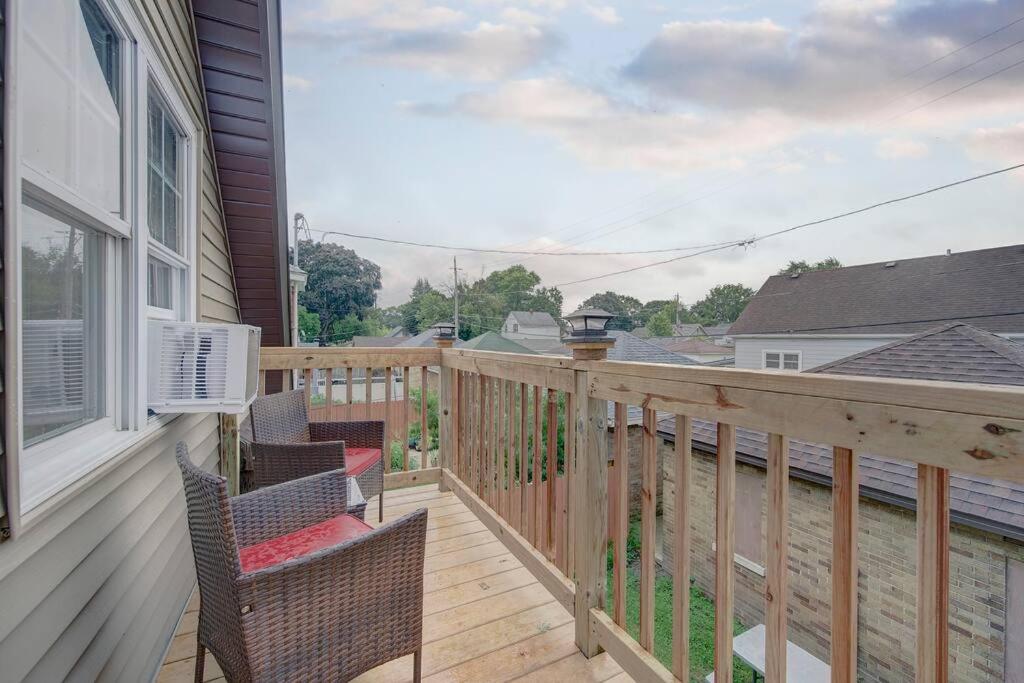a porch with chairs and a balcony with a view at Trendy Getaway: Pet-Friendly + 5 Min to Downtown in Milwaukee