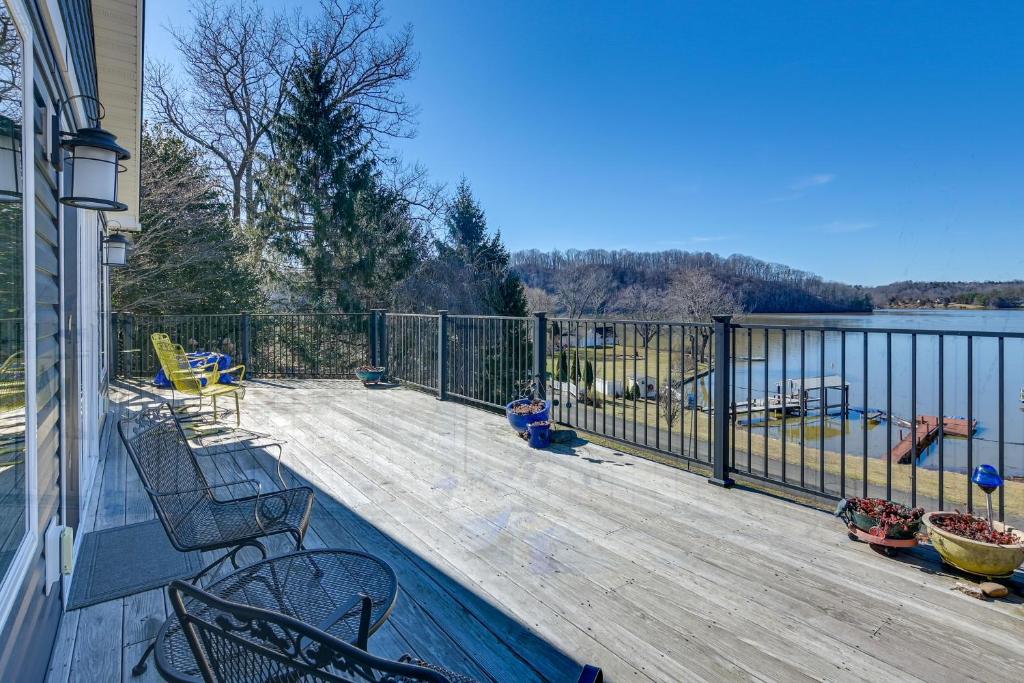 a balcony with a view of the water at Lakefront Radford Home with Wraparound Deck! in Radford
