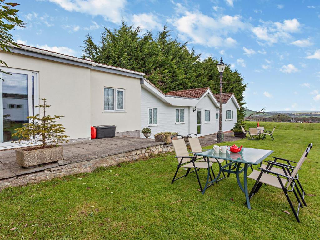 a table and chairs in the yard of a house at 2 bed property in Bath 37147 in Chew Magna