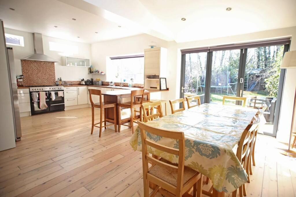 a kitchen with a table and chairs and a kitchen with a table and a kitchen at Spacious and bright 4 bed home in vibrant Chorlton in Manchester