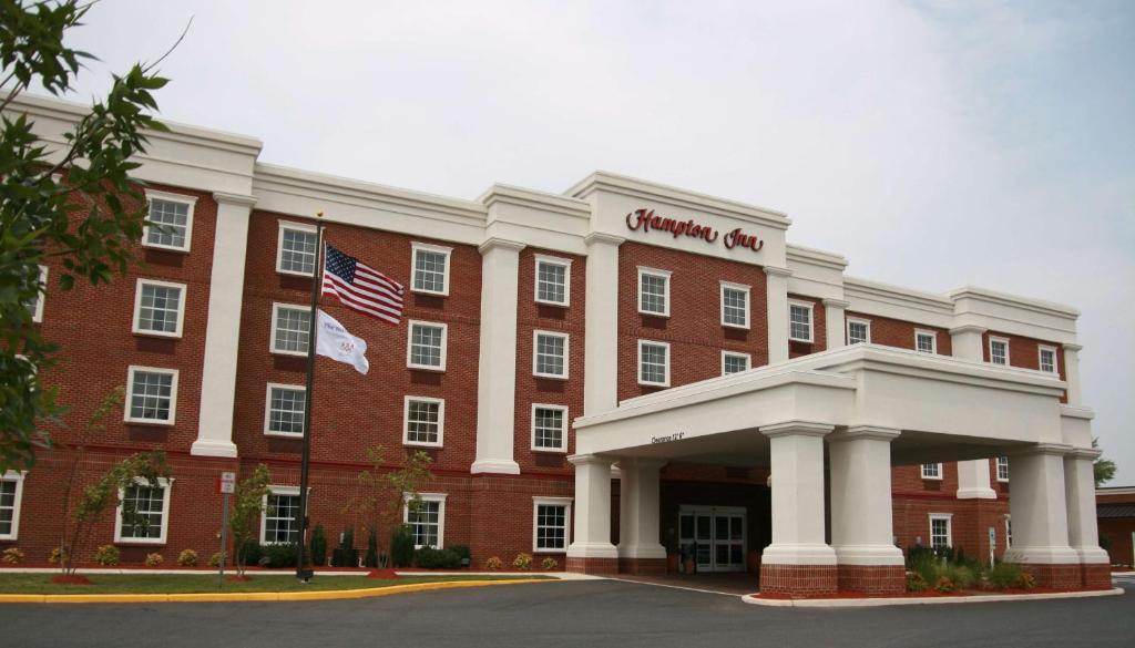 a large red brick building with an american flag at Hampton Inn Easton in Easton