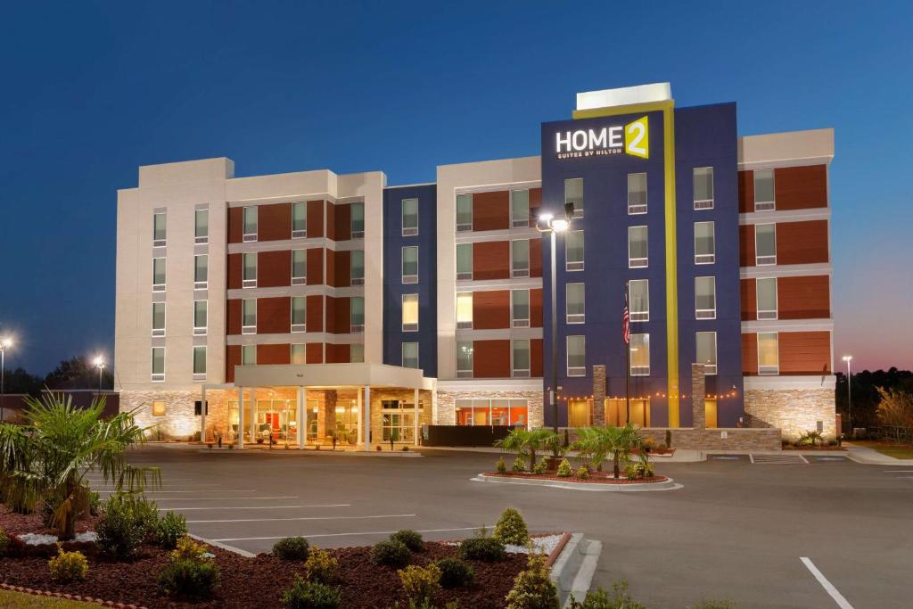 a hotel building with a home sign on it at Home2Suites by Hilton Florence in Florence