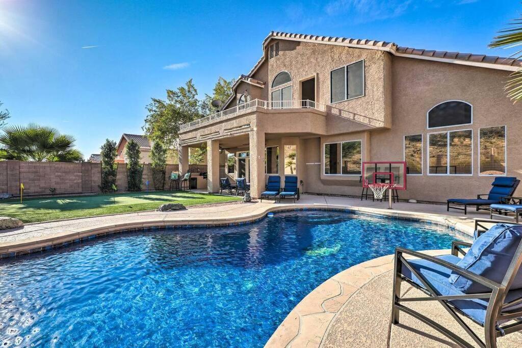 a house with a swimming pool in front of a house at Swim-Putt-Play! 5-BR Family Wonderland w/ Parking in Phoenix