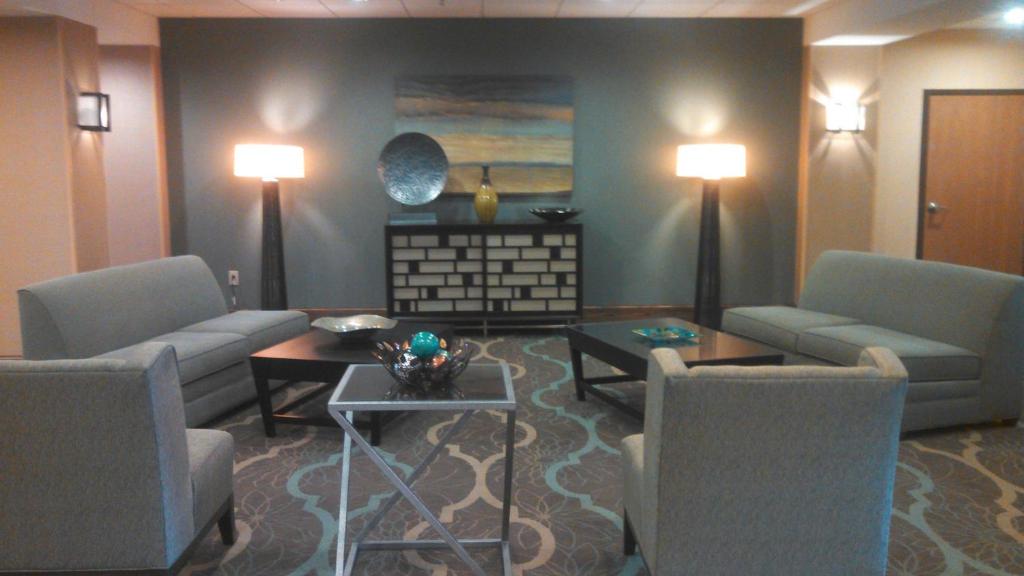 格林伍德的住宿－格林伍德漢普頓酒店，客厅配有两张沙发和一张桌子